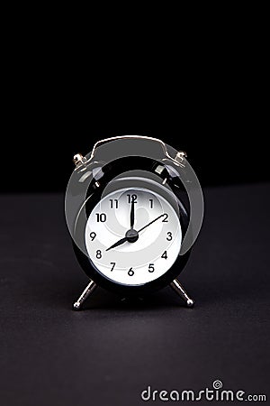 Black vintage alarm clock. Stock Photo