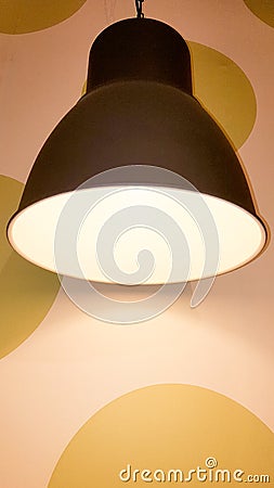 Black vintage light hanging lamp lighting fixture with fashion retro modern wall background Stock Photo