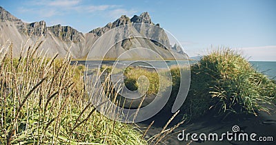 Black volcanic sand beach dunes in Stokksnes Vestrahorn mountain in the background Nature and ecology concept background Stock Photo