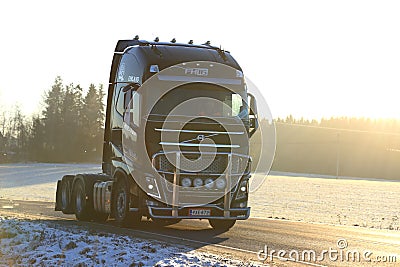Black Volvo FH Semi Trucking at Golden Sunset Editorial Stock Photo