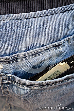 Black wallet with money, sticking out of the back pocket of th Stock Photo