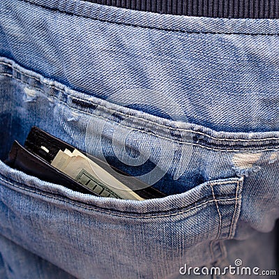 Black wallet with money, sticking out of the back pocket of th Stock Photo