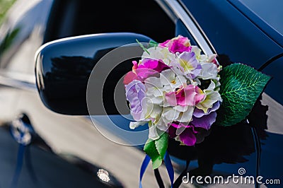 Black wedding car decorated with white roses Stock Photo