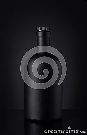 Black whiskey bottle on dark background Stock Photo