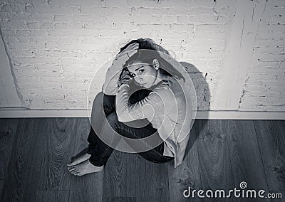 Black and whit portrait of young woman suffering from depression feeling hopeless and lonely Stock Photo