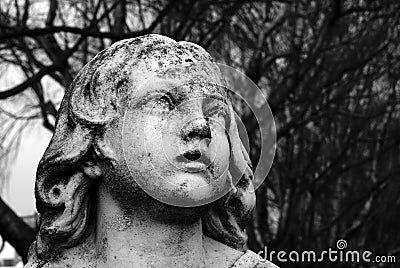 Black and White Angel Sculpture Close Up in Churchyard Cemetery Stock Photo