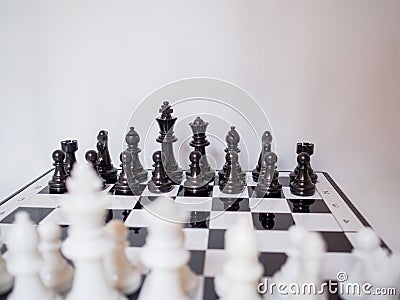 Black and white chess-Army are standing on a board with white background, challenges planning business strategy to success concept Stock Photo