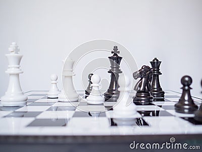 Black and white chess-Army are standing on a board with white background, challenges planning business strategy to success concept Stock Photo