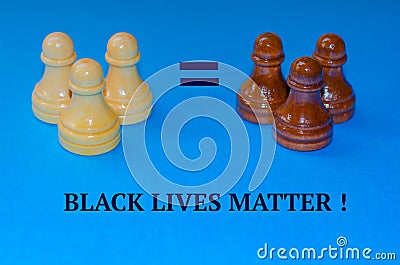 Black and white chess pieces on a blue background. The inscription Stop racism. Black lives matter Editorial Stock Photo
