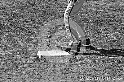 Black and white of close up of baseball base and players pants a Stock Photo