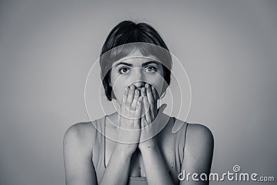 Portrait of a young attractive woman looking scared and shocked.Human expressions and emotions Stock Photo