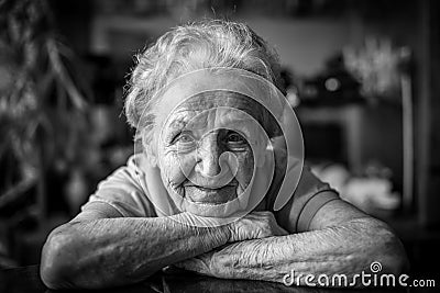 Black-and-white closeup portrait of an elderly positiv woman. Stock Photo