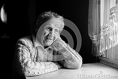 Black and white contrast portrait of an elderly happy woman. Stock Photo