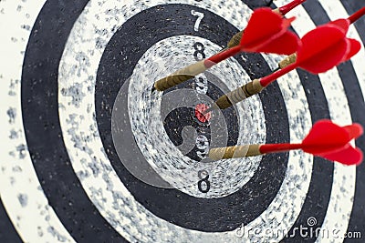 Black and white dartboard with the red darts in them Stock Photo