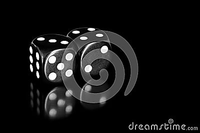 Black and White Dice Reflected on Black Stock Photo
