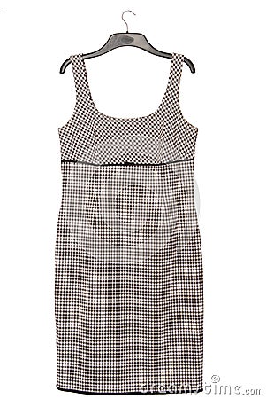 Black and white dress with checkered pattern is on coat-hanger, pinafore dress Stock Photo