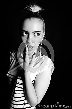 Black and white expressive portrait of a young stylish woman wearing stripes in the studio Stock Photo