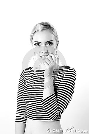 Black and white expressive portrait of a young stylish woman wearing stripes in the studio Stock Photo