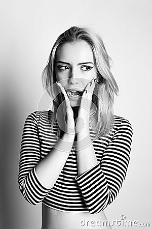 Black and white expressive portrait of a young stylish woman wearing stripes in the studio Stock Photo
