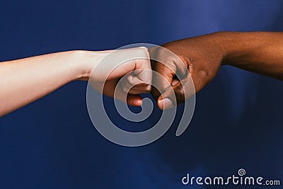 Black and white hand, fist bump gesture, contrast Stock Photo