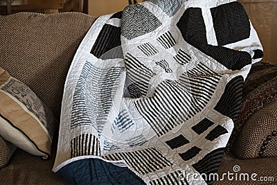 Handmade quilt tossed on a couch Stock Photo