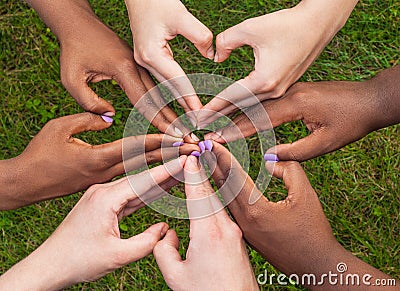 Black and white hands in heart shape, interracial friendship concept Stock Photo