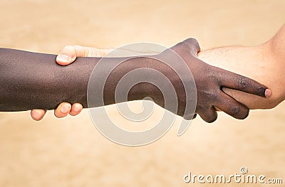 Black and white hands in modern handshake against racism Stock Photo