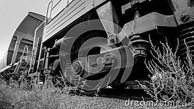 Black and white image of big cargo train cars on industrial railroad Stock Photo