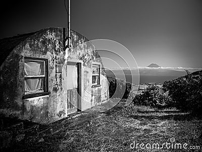 Black and white image of building in the foreground and the mountain of Pico in the background Stock Photo