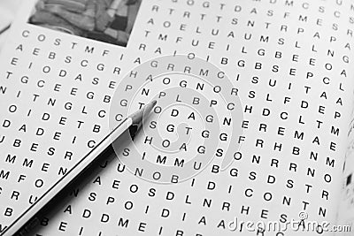 Black and white image of a mystery word on which there is a pencil Stock Photo