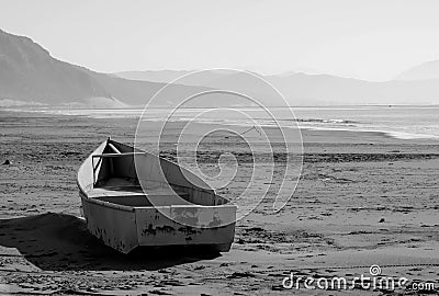 Black white image of a boat on the sea shore, after the storm Stock Photo