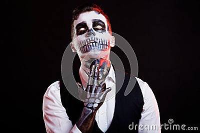Terrible man with white eyes, killing himself with creative make-up for the Halloween party. Stock Photo