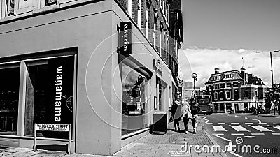 Black and White Image Three Anonymous Girls Or Women Walking Past A Wagamama Asian Food Restaurant Editorial Stock Photo
