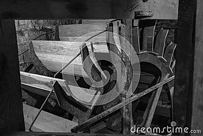 A black and white image of the wheel of a watermill in Devon, England, taken from the right of the wheel Stock Photo