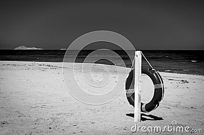Black and white of lifebuoy on a deserted beach Stock Photo