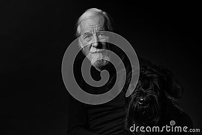 Black and white low key studio portrait of old man and his dog Editorial Stock Photo