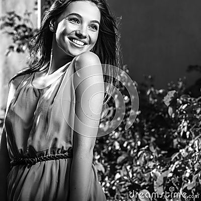 Black-white outdoor portrait of beautiful emotional young brunette woman in stylish dress Stock Photo