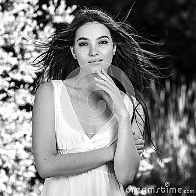 Black-white outdoor portrait of beautiful emotional young brunette woman in stylish dress Stock Photo