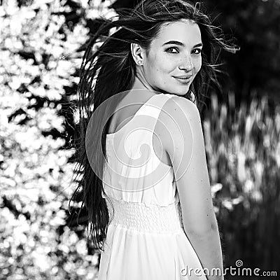 Black-white outdoor portrait of beautiful emotional young brunette woman in stylish dress Stock Photo