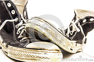 Black and white pair of Men`s or Teenager`s Grungy Dirty retro High Top tennis shoes Stock Photo