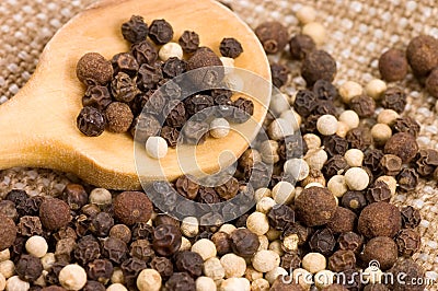 Black and white Peppercorns on a wooden spoon Stock Photo