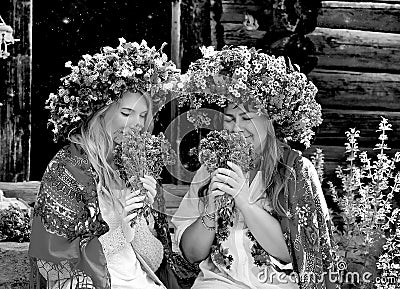 Black and white phot girls in large flower wreaths, Ukrainian national scarves Stock Photo