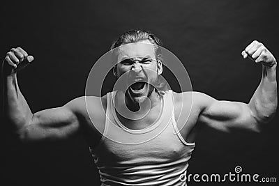 Black and white photo. angry sportsman showing his hard musculars Stock Photo