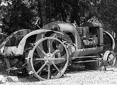 Antique steel wheel farm tractor under a shade tree Stock Photo