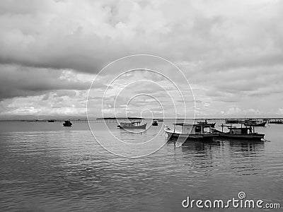 Black and white photo of beautiful fishermen boats at the sea Stock Photo