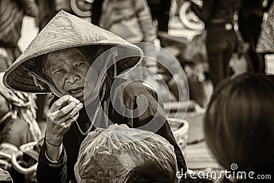 Black and white photo of an elderly woman at market Editorial Stock Photo