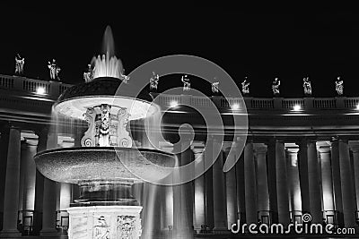 Black and white photo of fountain at St. Peter`s Square in Vatican at night Editorial Stock Photo