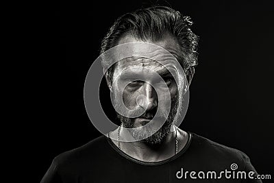 Black and white photo of mid aged man showing severe emotion. Stock Photo