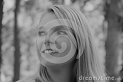 Black and white photo of the profile of a smiling woman`s face Stock Photo