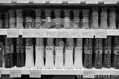 Black and White photo of sea salt, pepper, spices, herbs, coriander etc put in shelves for sale. Shelves with herbs, spices and Editorial Stock Photo